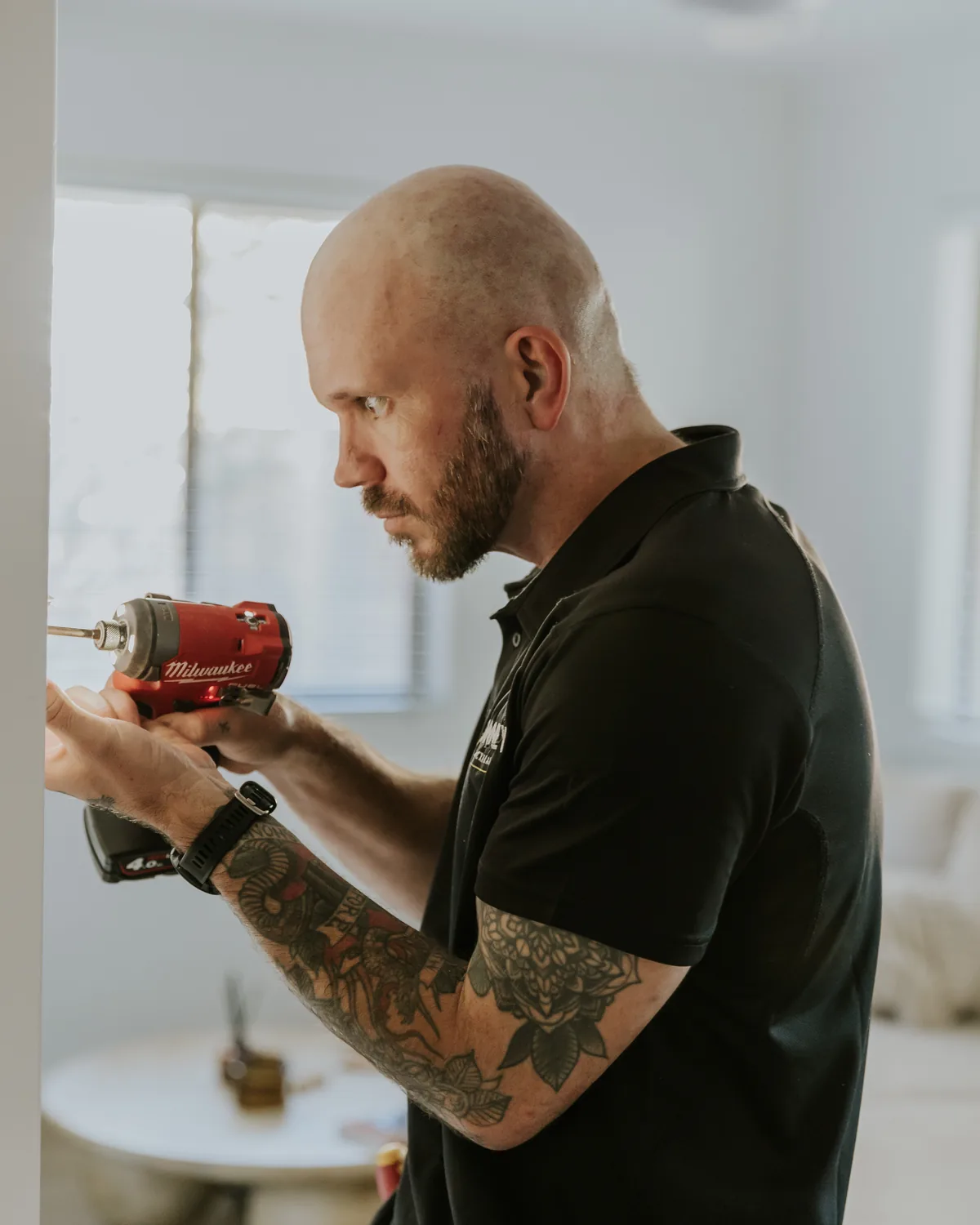 Matthew Bonney fitting a power point in a Brisbane home