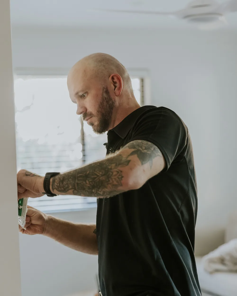 Matthew Bonney working on a power point in a Brisbane unit